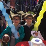 Partners in Education event, 2 young children holding a party balloon