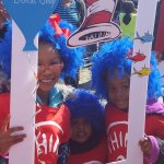 Partners in Education event, 2 young children behind a cut out frame