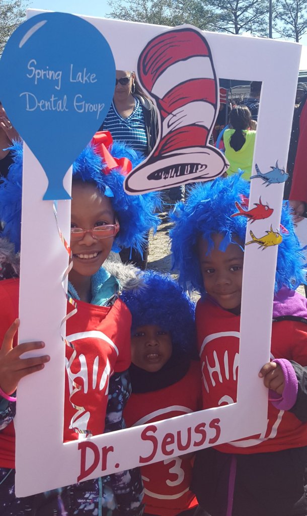 Partners in Education event, 2 young children behind a cut out frame