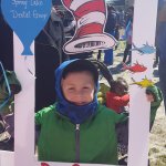 Partners in Education event, a boy behind a cut out frame
