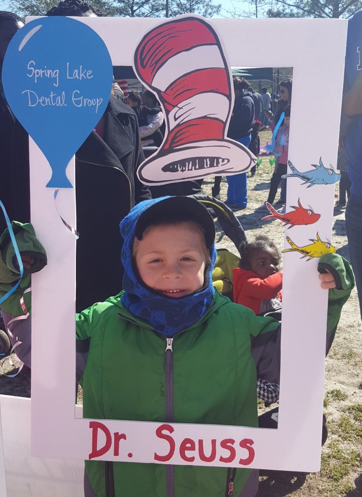Partners in Education event, a boy behind a cut out frame