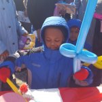 Partners in Education event, a young boy in front of a table with candies