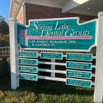Office sign with doctor names and credentials.